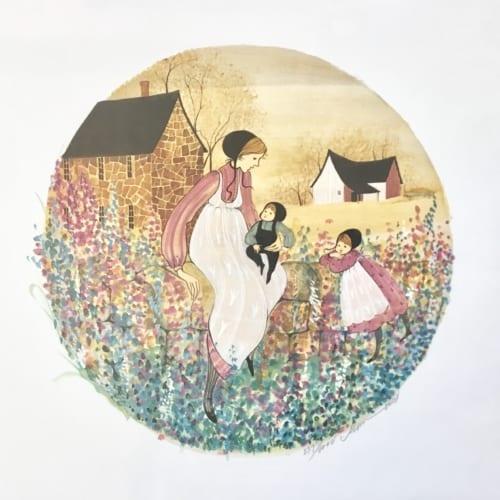 Cottage Wall limited edition print by P Buckley Moss features a mother with two children in a rural setting with barn, house sitting on a wall with a growth of flowers. Colors of blue, green, tan, cream pink and mauve and golden shades of yellow.