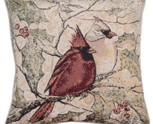 Tapestry pillow with male and female cardinals perched on a branch. Background of holly leave and branches.