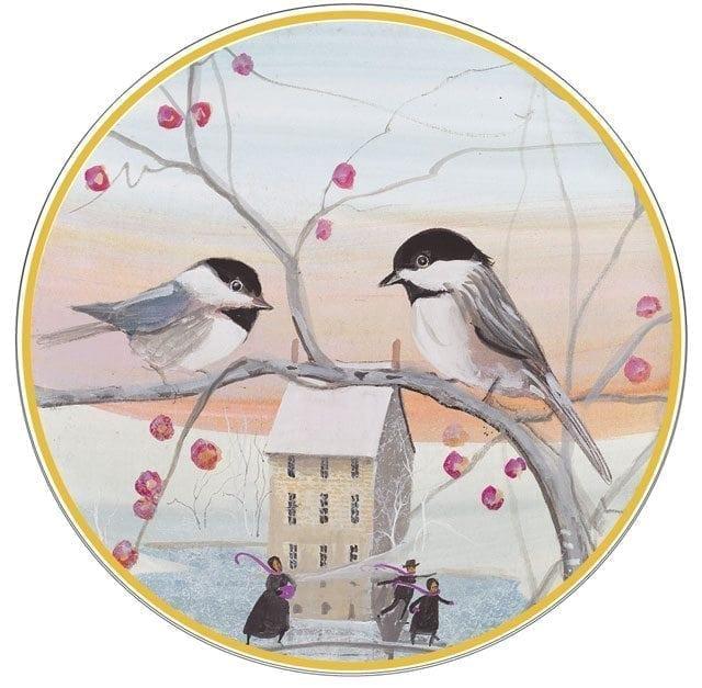 Limited edition porcelain ornament by P Buckley Moss featuring two birds on tree branches with berries in a soft background of peach and blue.