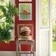 Beautiful shade of red on the walls with matching artwork to enhance the entryway area.