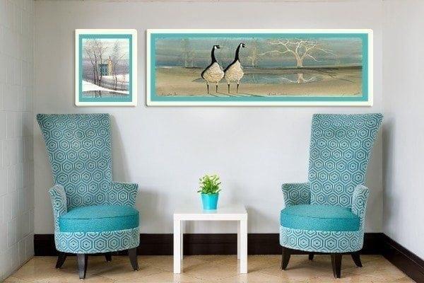 Beach Comber limited edition print is featured in this artwork. Framed in a white frame and the focal point of living space between chairs