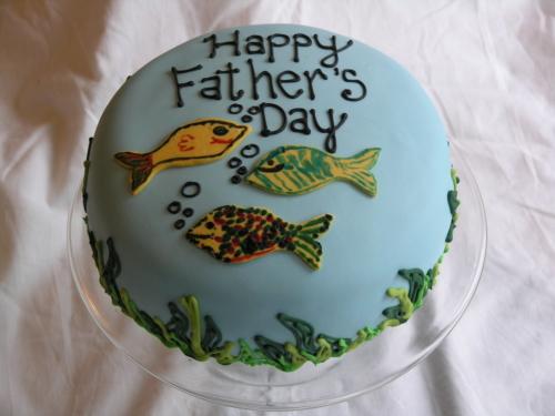 Special cake for Father's Day or anytime you feel like making dad feel special. Fishing theme with different colors of fish on a water colored background with seaweed added of course.