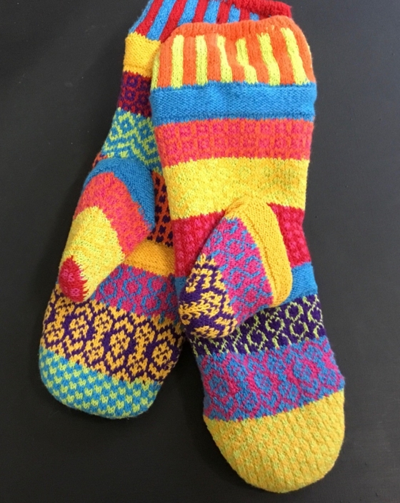 Solmate Sunny mittens feature bright yellow, orange, aqua, and a bit of dark pink. Solmate Sunny mittens feature bright yellow, orange, aqua, and a bit of dark pink.