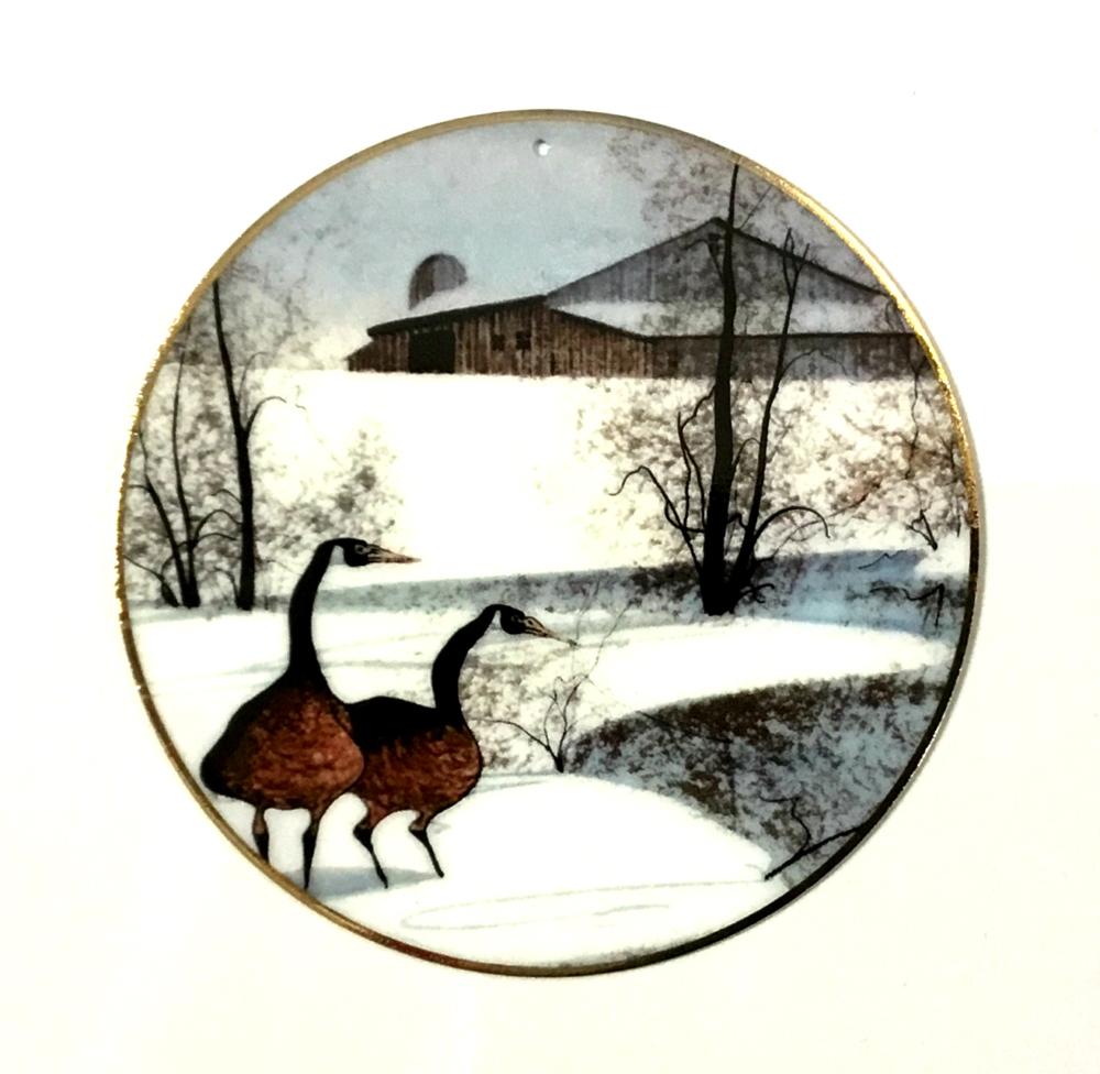 Winter Pond ornament by P Buckley Moss features two geese by pond with barn in background.