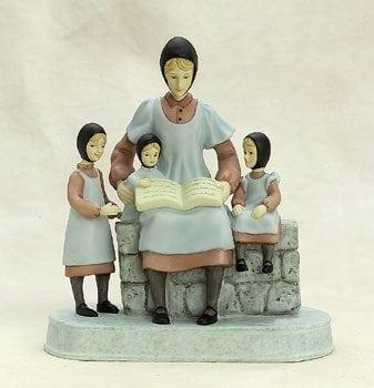 Reading to My Girls figurine by P Buckley Moss. Mother reading to three small girls. Colors are soft blue