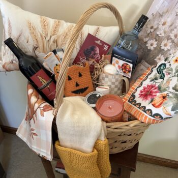 Fall Decorative Box fundraiser basket with autumn décor, candles, wine, salted caramel vodka, gift cards, scarf, mug and pumpkin accessories.