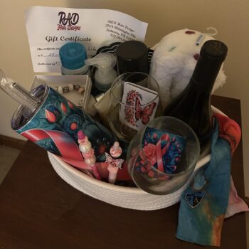 #6 RAD Basket with RAD Hair Designs gift certificate, wine and glasses, tumbler, slippers, hair products, head wraps and self-care gifts.