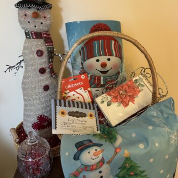 #10 Snowman Basket with Cinemark gift cards, Nothing Bundt Cakes vouchers, stuffed snowman, snowman tree skirt, candy dish and holiday napkins.
